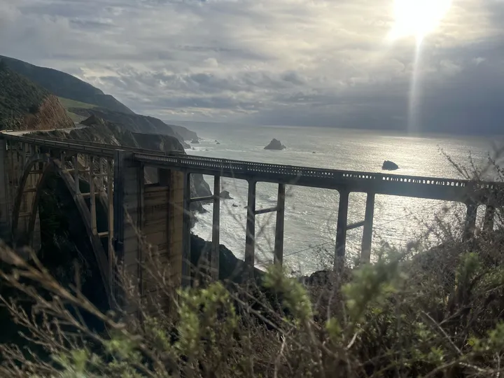 Bixby Bridge above the Big Sur coast, with sunlight on the ocean.